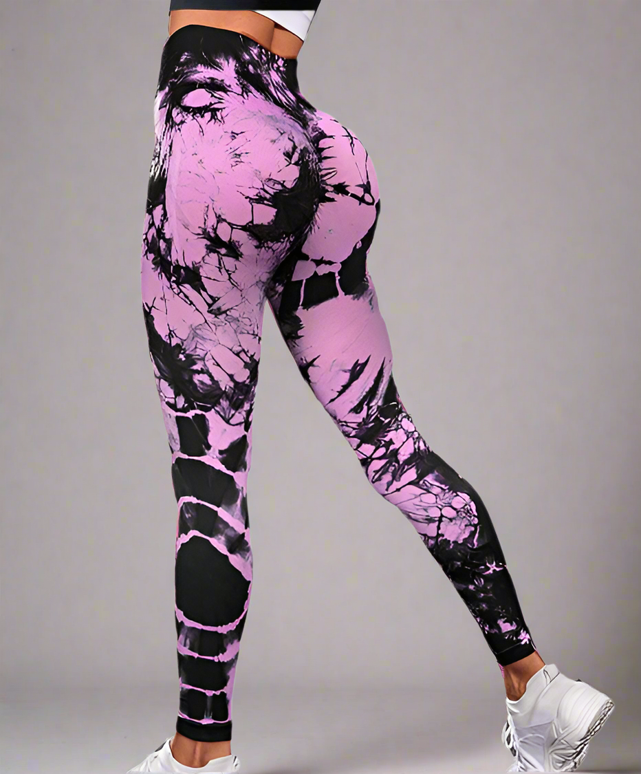 Pink and black tie-dye leggings worn by a person on a white background