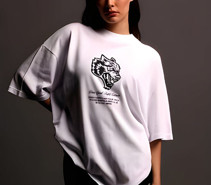 Person wearing a white t-shirt with a graphic design on a dark background